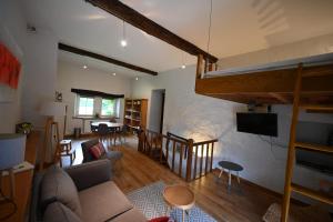 a living room with a couch and a bunk bed at Le Nid d'à côté in Méan
