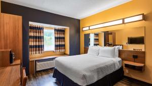 a hotel room with a bed and a television at SureStay Plus Hotel by Best Western Keyser in Keyser +26 photos