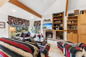 a living room with two couches and a fireplace at Mountain View Condo - Hot Tub Fireplace in Avon +35 photos