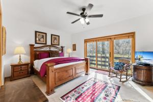 a bedroom with a bed and a ceiling fan at Mountain View Condo - Hot Tub Fireplace in Avon