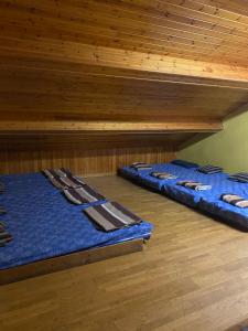 two bunk beds in a room with wooden ceilings at Refugi La Basseta in Vall de Castellbò