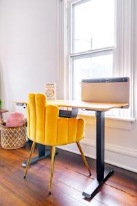 a desk with a computer and two yellow chairs at Jungle House Chillicothe Sleeps 12 Downtown Ohio Free Parking - Walk to Historic District - 3BR Luxury Home - Pet Friendly - King Beds - Over 5,800 Five Star Stays in Chillicothe