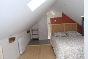 a bedroom with a bed in a attic at Les campanules in Lanvénec