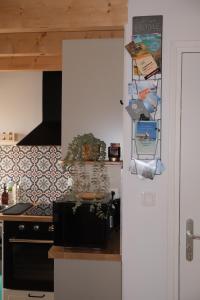 a kitchen with a counter and a stove top oven at Les campanules in Lanvénec