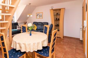 a dining room and living room with a table and chairs at Ferienpark Freesenbruch Wohnung 3 5 - Muschelsucher in Zingst