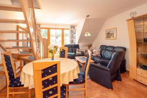 a living room and dining room with a table and chairs at Ferienpark Freesenbruch Wohnung 3 5 - Muschelsucher in Zingst