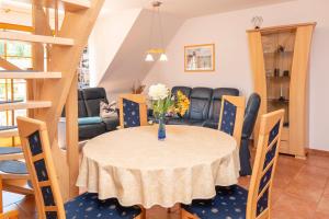 a dining room and living room with a table and chairs at Ferienpark Freesenbruch Wohnung 3 5 - Muschelsucher in Zingst