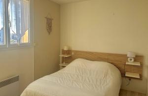a bedroom with a white bed and a window at Agréable villa avec piscine à 100 m de la plage - 10B14J35 in Le Barcarès +18 photos