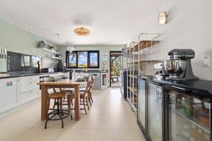 a kitchen with a table and chairs in it at Oasis guesthouse, Boutique Style Hotel in Kralendijk