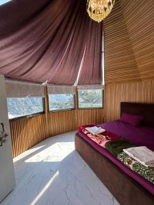 a bedroom with a bed and a chandelier at LA Foresta resort by Utopia in Shivpuri