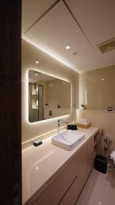 a bathroom with a sink and a large mirror at Mountain View i city October in 6th Of October +18 photos