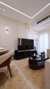 a living room with a large television and a couch at Mountain View i city October in 6th Of October