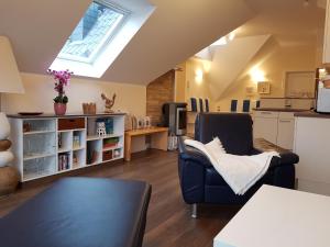 a kitchen and living room with a skylight at Neue Reihe 28 - Wohnung Vogelnest in Zingst