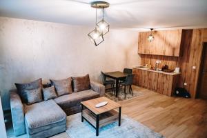 a living room with a couch and a table at VM Apartments Zabljak in Razvršje