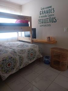 a bedroom with a bunk bed and a sign on the wall at Airport Hostel in Ciudad Juárez +11 photos