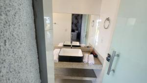 a bathroom with a sink and a mirror at Pousada Recanto e Aconchego Capitolio in Capitólio +19 photos
