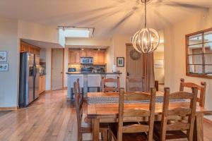 a dining room and kitchen with a table and chairs at Cascade Penthouse by Canadian Rockies Vacation Rentals in Canmore