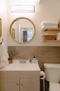 a bathroom with a sink and a mirror at Cozy Downtown Havens in Moscow +113 photos