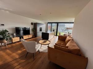 a living room with a couch and a table at Haus Am Anger Dornbirn in Dornbirn