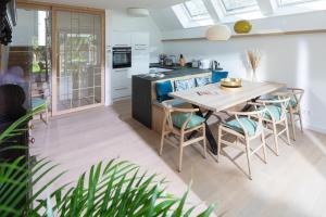 a kitchen with a dining room table and chairs at Strandhaus Südwesthörn in Norderney