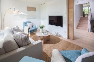 a living room with a couch and a table at Strandhaus Südwesthörn in Norderney