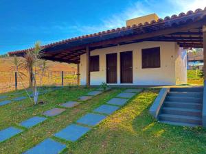 a small house with a pathway in front of it at Chalés Vale da Roça in Capitólio