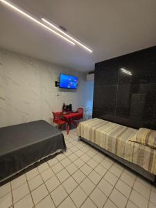 Et tv og/eller underholdning på No coração da Praia do Frances