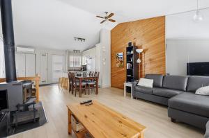 a living room with a couch and a table at The refuge of the slopes, ski in, ski out in Stoneham