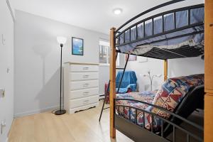 a bedroom with a bunk bed and a dresser at The refuge of the slopes, ski in, ski out in Stoneham