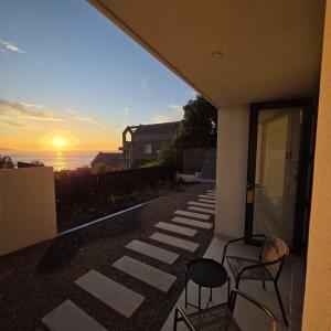 a patio with a view of the ocean at sunset at Arka Hotel in Viña del Mar