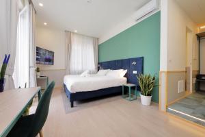 a bedroom with a bed and a blue wall at Proja Housing Romagnosi20 in Rome