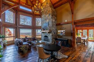 a large living room with a stone fireplace at Bailey's Creek Lodge in Blowing Rock