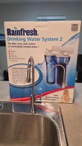 uma caixa de sistema de água potável da floresta tropical ao lado de uma pia em M&M's Maple Bay Mountain Guesthouse em Duncan mais 37 fotografias