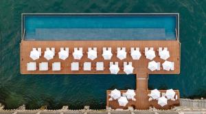 an aerial view of a wooden board with white papers on the water at Mandarin Oriental, Lago di Como in Blevio