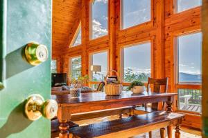 een houten eetkamer met een tafel en ramen bij Hot Tub Epic View Fire Pit 40 Acres in Old Fields