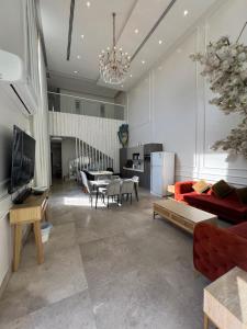 a living room with a red couch and a table at شاليه كادي cady resort in Al Khobar