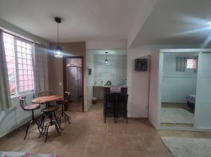 una stanza con tavolo, sedie e cucina di Loft FMIT Medicina a Itajubá