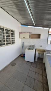 a kitchen with a counter and a sink in a room at Residencial Ana Jacinta in Campinas