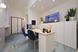an office with a desk and chairs in a room at Proja Housing Romagnosi20 in Rome