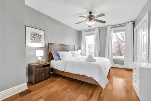 a bedroom with a bed and a ceiling fan at Downtown Lancaster Luxury 4BR - Garage & Parking in Lancaster