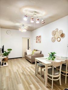 a living room with a table and a couch at D,A-House OSAKA in Osaka