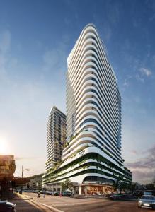 a tall white building with a street in front of it at voco Gosford by IHG in Gosford