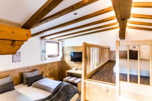 a room with a bunk bed and a tv at ALPENHOTEL TYROL - B&B - ADULTS ONLY - Alpines Lifestylehotel mit NaturSPA & Wellness in Pertisau