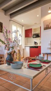 a table with plates and bowls on it in a kitchen at La Maisonnette du Soleil in Gallargues-Le-Montueux