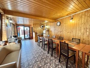 a dining room with wooden walls and tables and chairs at Casa Adrian in Predeal