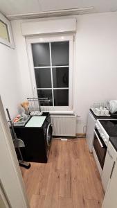 a small kitchen with a microwave and a window at Pension Urbanstraße 46 in Stuttgart +13 photos