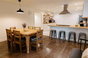 a kitchen with a wooden table and some chairs at Boxwood Haven in Moscow