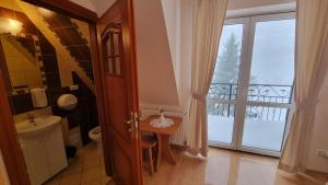 a bathroom with a sink and a toilet and a window at Willa u Skrajnioka in Czerwienne +57 photos