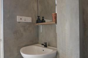 a bathroom with a sink and a toilet in a room at The Stables Oceanfront Hotel Midigama in Midigama East +84 photos