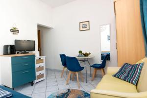 a living room with a couch and a table at Apartments Beach house Blace in Blace